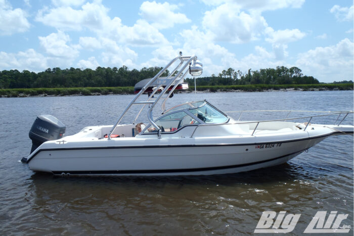 white 1997 ski centurian 2100 boat on water with polished cuda wakeboard tower