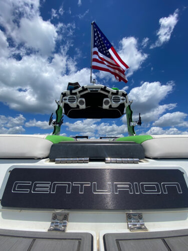 View of the rear of a Centurion boat showing the Big Air Flag Holder mounted onto the top with the American Flag waving