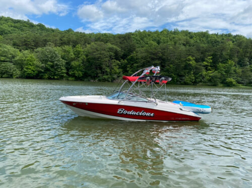 red and white regal boat on the water showing a big air haus tower mounted