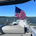 Betsy Ross Flag waving around mounted on a Pontoon boat tower via a Big Air Flag Holder mounted on a 46 inch pole.