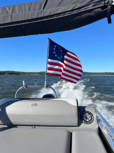 Betsy Ross Flag waving around mounted on a Pontoon boat tower via a Big Air Flag Holder mounted on a 46 inch pole.