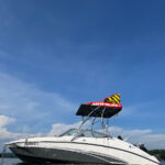 A white yamaha boat in the middle of the water showing a Big Air Vapor tower with a Tube Top Bimini