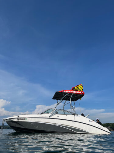 A white yamaha boat in the middle of the water showing a Big Air Vapor tower with a Tube Top Bimini