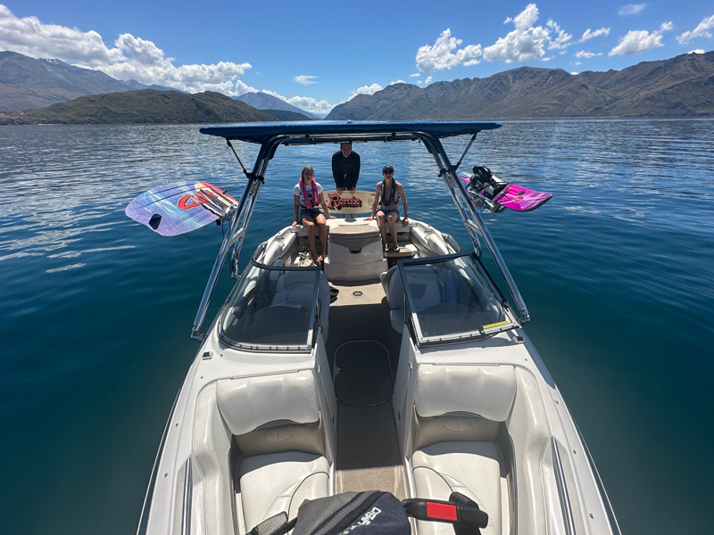 customer photo of a family on the back of a 2005 Four Winns boat with a Big Air Cuda tower and Super Shadow Bimini