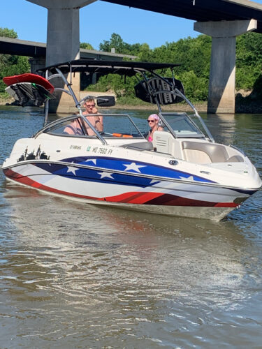 Boat with an American Flag wrap on it and boat tower accesories