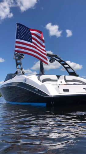 2022 Yamaha 195s boat sitting on the water showing an American flag waving in the wind