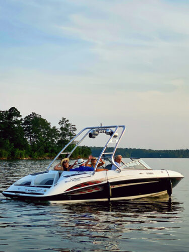 black, white, and yellow, Yamaha boat with a Big Air Cuda tower mounted at the stern sweeping to the bow.