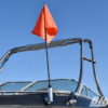 Big Air Hull Mounted Flag Holder mounted onto a black boat with a orange rider down flag inserted