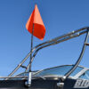 Big Air Hull Mounted Flag Holder mounted onto a black boat with a orange rider down flag inserted