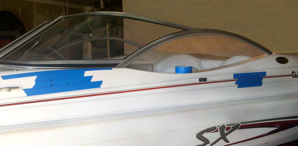 Installation of a wakeboard tower showcasing masking tape where the tower mounts will be attached. 